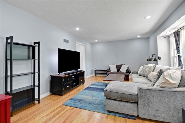 809 E 110th St, Kansas City, MO 64131 - living area featuring light wood-style floors, recessed lighting, and a textured ceiling
