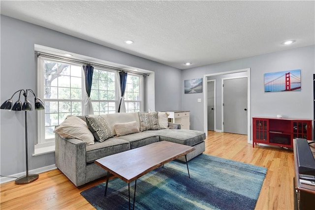 809 E 110th St, Kansas City, MO 64131 - living room with wood finished floors, a textured ceiling, and recessed lighting