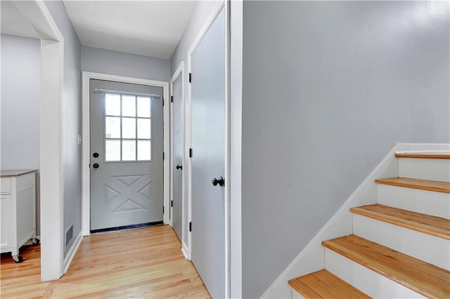 809 E 110th St, Kansas City, MO 64131 - doorway featuring light wood-type flooring and stairway