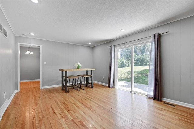 809 E 110th St, Kansas City, MO 64131 - empty room with crown molding, light wood finished floors, a textured ceiling, and recessed lighting