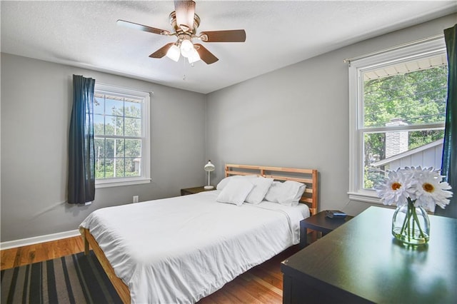 809 E 110th St, Kansas City, MO 64131 - bedroom with wood finished floors, a ceiling fan, and a textured ceiling
