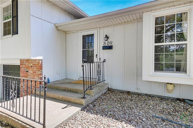 809 E 110th St, Kansas City, MO 64131 - view of exterior entry with board and batten siding and brick siding