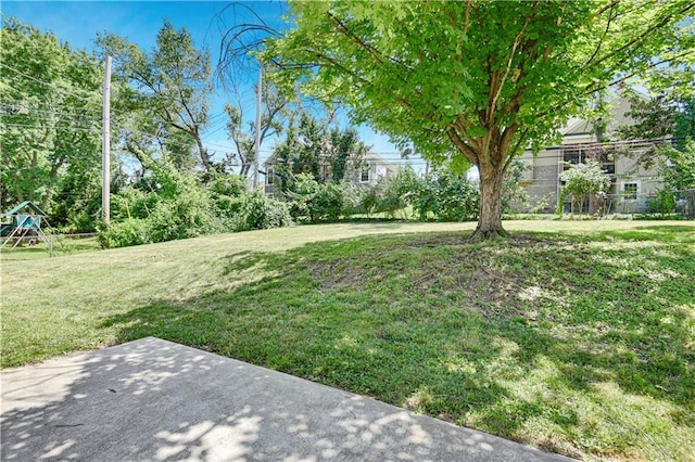 809 E 110th St, Kansas City, MO 64131 - view of green lawn featuring a patio and a playground