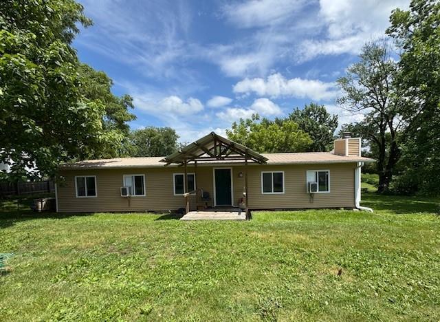 2745 169th Hwy, Trimble, MO 64492 - back of property with a chimney, a yard, a patio, and cooling unit