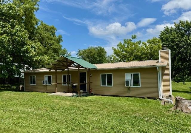 2745 169th Hwy, Trimble, MO 64492 - rear view of house featuring a lawn, a chimney, and a patio