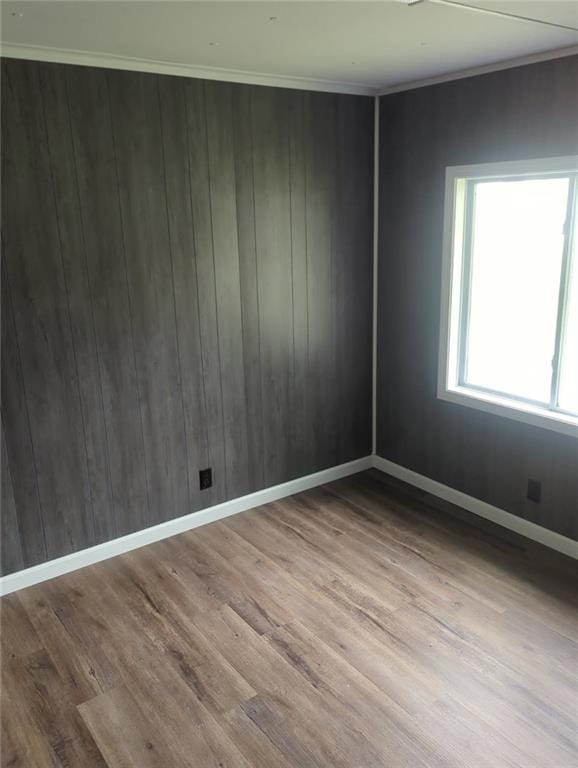 2745 169th Hwy, Trimble, MO 64492 - empty room featuring wood finished floors, wood walls, and crown molding