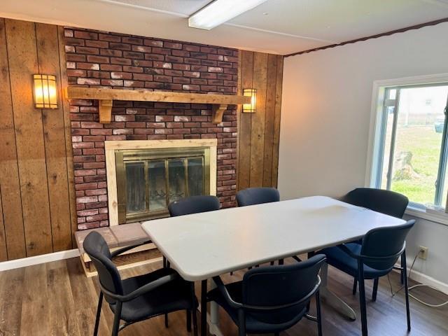 2745 169th Hwy, Trimble, MO 64492 - dining area with wood walls, wood finished floors, and a brick fireplace