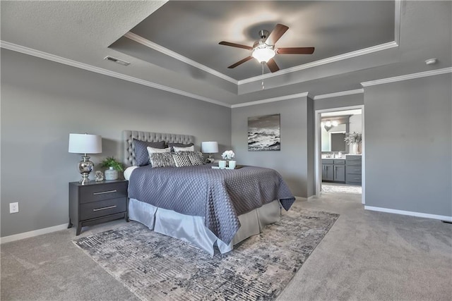 2749 W Dartmouth St, Olathe, KS 66061 - carpeted bedroom with a tray ceiling, crown molding, ceiling fan, and connected bathroom