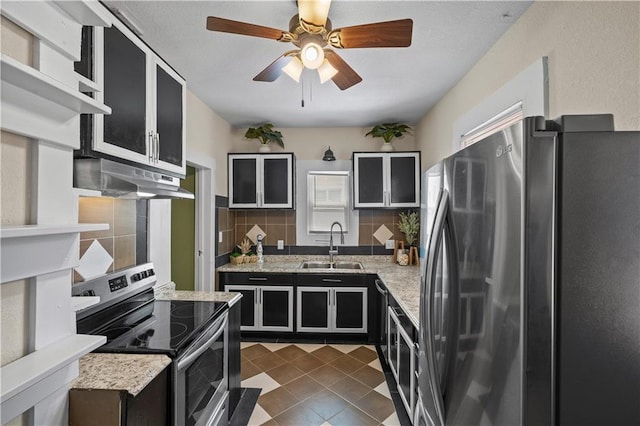 3230 Bellefontaine Ave, Kansas City, MO 64128 - kitchen featuring appliances with stainless steel finishes, under cabinet range hood, dark cabinets, backsplash, and a ceiling fan