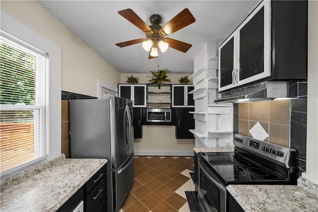 3230 Bellefontaine Ave, Kansas City, MO 64128 - kitchen with appliances with stainless steel finishes, open shelves, dark cabinetry, under cabinet range hood, and ceiling fan