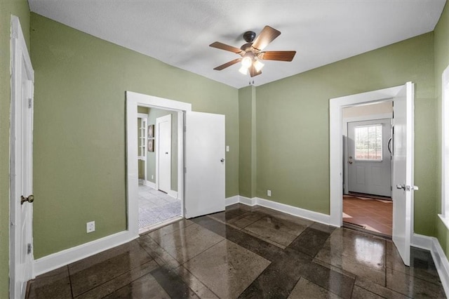3230 Bellefontaine Ave, Kansas City, MO 64128 - unfurnished bedroom with granite floors and ceiling fan