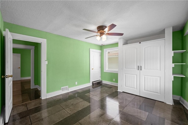 3230 Bellefontaine Ave, Kansas City, MO 64128 - unfurnished bedroom featuring a textured ceiling and ceiling fan