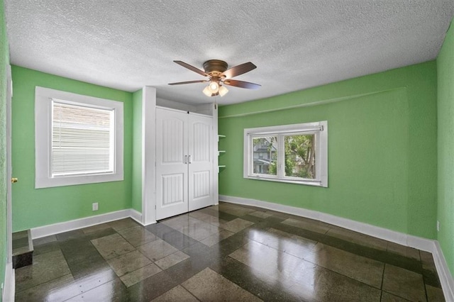 3230 Bellefontaine Ave, Kansas City, MO 64128 - unfurnished bedroom with a closet and ceiling fan
