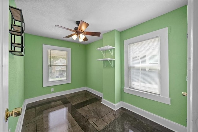 3230 Bellefontaine Ave, Kansas City, MO 64128 - unfurnished room featuring baseboards and a ceiling fan