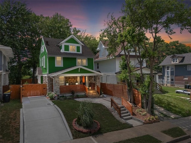 3230 Bellefontaine Ave, Kansas City, MO 64128 - view of front of home featuring stone siding and a gate