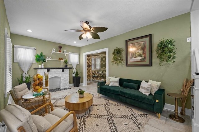 3230 Bellefontaine Ave, Kansas City, MO 64128 - tiled living area with a stone fireplace, ceiling fan, and recessed lighting
