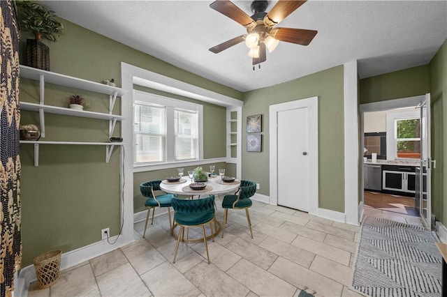3230 Bellefontaine Ave, Kansas City, MO 64128 - dining room featuring a ceiling fan and a textured ceiling
