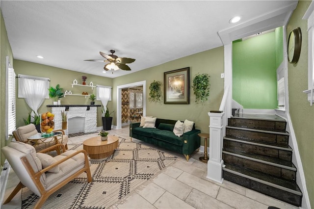 3230 Bellefontaine Ave, Kansas City, MO 64128 - living room featuring ceiling fan, tile patterned flooring, stairs, a fireplace, and recessed lighting
