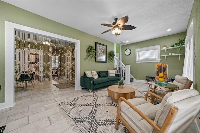 3230 Bellefontaine Ave, Kansas City, MO 64128 - living room featuring stairs and ceiling fan