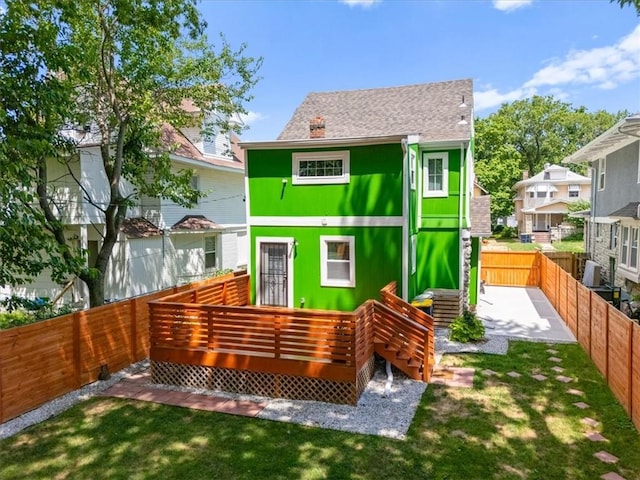 3230 Bellefontaine Ave, Kansas City, MO 64128 - rear view of property featuring a fenced backyard and a deck