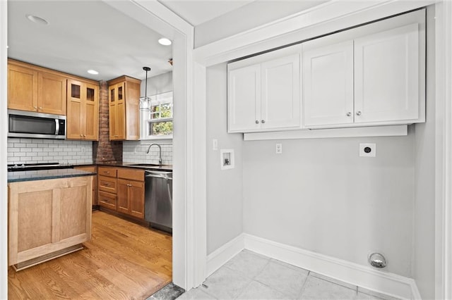 1535 W 75th St, Kansas City, MO 64114 - kitchen featuring appliances with stainless steel finishes, tasteful backsplash, recessed lighting, glass insert cabinets, and dark countertops