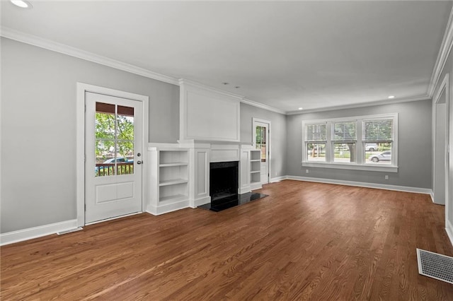 1535 W 75th St, Kansas City, MO 64114 - unfurnished living room featuring plenty of natural light, a fireplace, crown molding, dark wood-style floors, and recessed lighting
