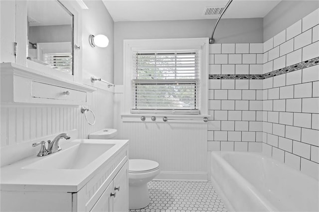 1535 W 75th St, Kansas City, MO 64114 - full bath with wainscoting, vanity, bathtub / shower combination, and tile patterned floors