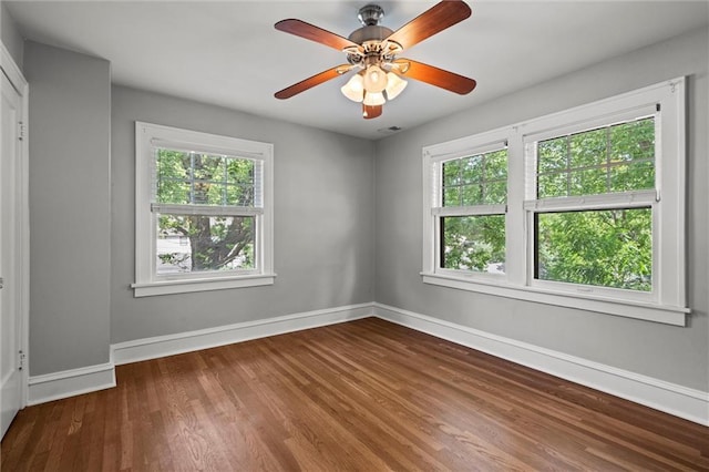1535 W 75th St, Kansas City, MO 64114 - empty room featuring plenty of natural light, wood finished floors, and ceiling fan