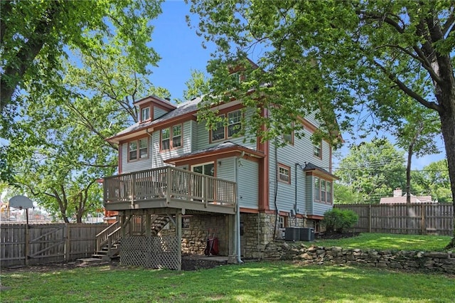1535 W 75th St, Kansas City, MO 64114 - back of property featuring stairway, a deck, a fenced backyard, and stone siding