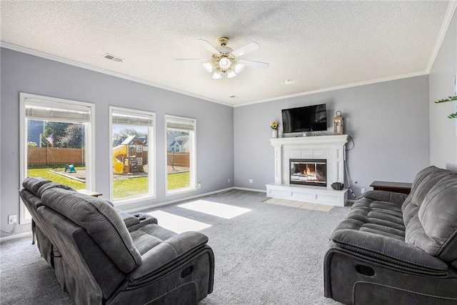 2417 SW Woodhaven Ln, Lees Summit, MO 64082 - carpeted living room with healthy amount of natural light, ceiling fan, crown molding, a tile fireplace, and a textured ceiling