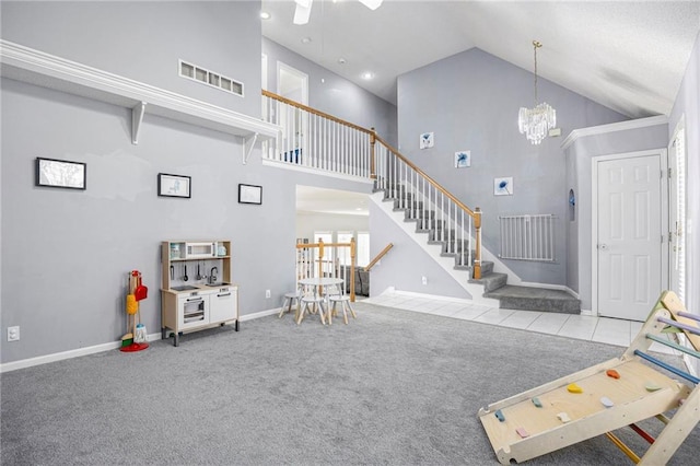 2417 SW Woodhaven Ln, Lees Summit, MO 64082 - carpeted living area featuring high vaulted ceiling, stairway, and a chandelier