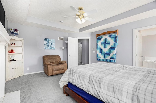 2417 SW Woodhaven Ln, Lees Summit, MO 64082 - bedroom with carpet floors, a raised ceiling, a textured ceiling, ensuite bathroom, and a ceiling fan