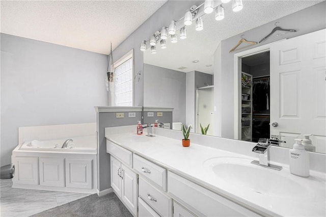 2417 SW Woodhaven Ln, Lees Summit, MO 64082 - full bath featuring a shower with shower door, double vanity, a garden tub, a textured ceiling, and a walk in closet