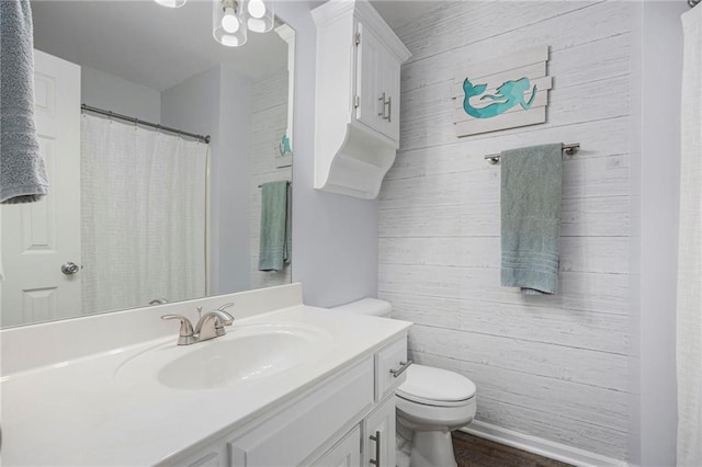 2417 SW Woodhaven Ln, Lees Summit, MO 64082 - full bath featuring vanity, wood walls, wood finished floors, and a shower with curtain