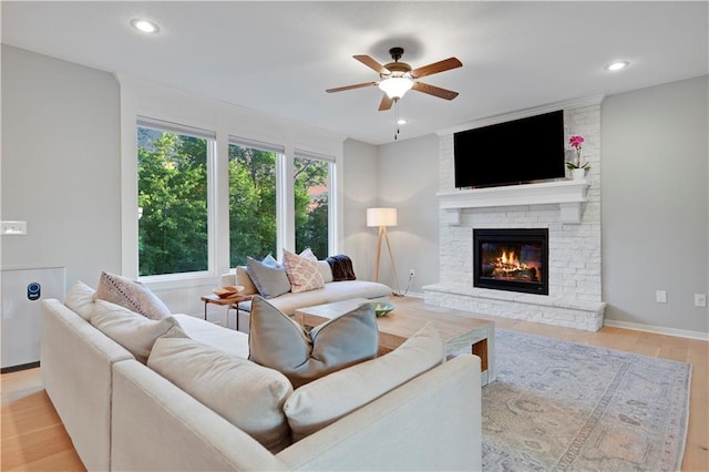 20487 W 108th St, Olathe, KS 66061 - living room with ceiling fan, a stone fireplace, light wood-style flooring, and recessed lighting