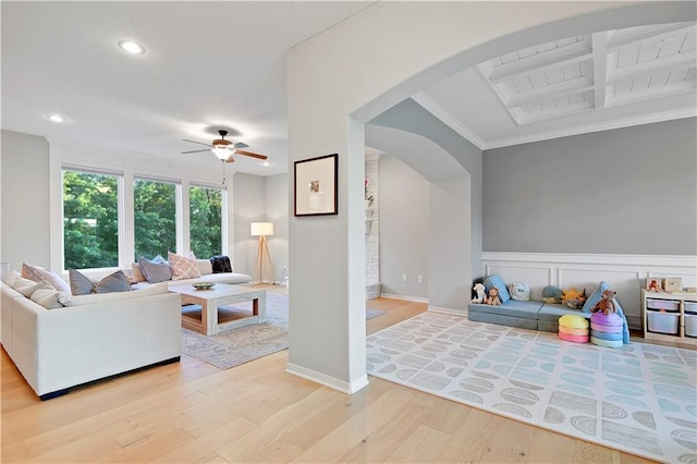 20487 W 108th St, Olathe, KS 66061 - living room with arched walkways, light wood-style flooring, ceiling fan, ornamental molding, and recessed lighting