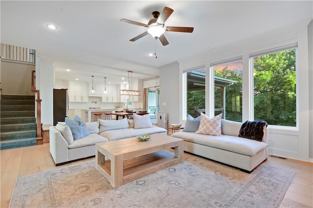 20487 W 108th St, Olathe, KS 66061 - living area with ceiling fan, light wood finished floors, recessed lighting, and stairs