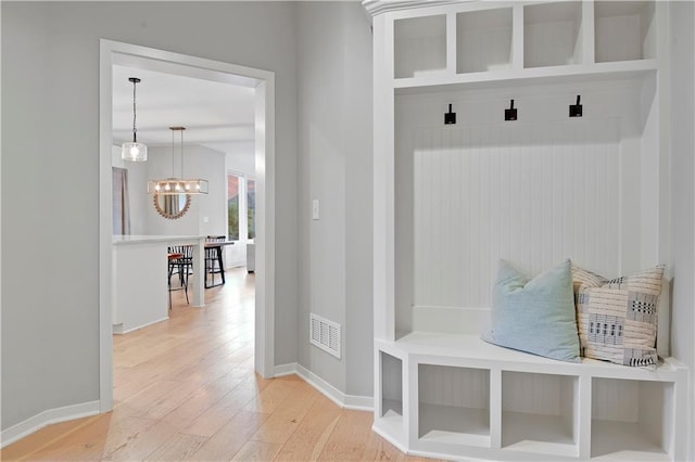 20487 W 108th St, Olathe, KS 66061 - mudroom with a chandelier and light wood-style flooring