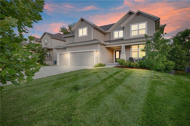 20487 W 108th St, Olathe, KS 66061 - view of front of home with driveway, a garage, stucco siding, a front yard, and a porch