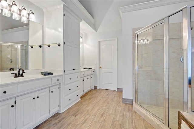 5010 W 161st Ter, Overland Park, KS 66085 - full bath featuring double vanity, a stall shower, ornamental molding, and wood finished floors