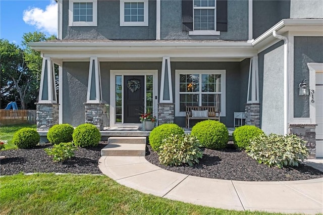 316 SE Hackamore Dr, Lees Summit, MO 64082 - entrance to property with stucco siding, a porch, and stone siding