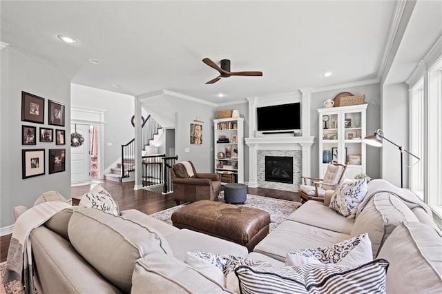 316 SE Hackamore Dr, Lees Summit, MO 64082 - living room featuring wood finished floors, stairs, a ceiling fan, a glass covered fireplace, and recessed lighting