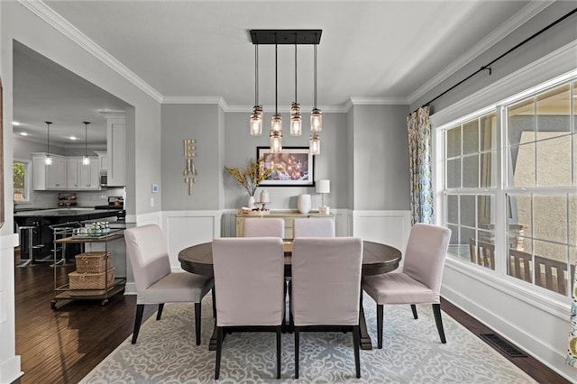 316 SE Hackamore Dr, Lees Summit, MO 64082 - dining space featuring dark wood finished floors and ornamental molding