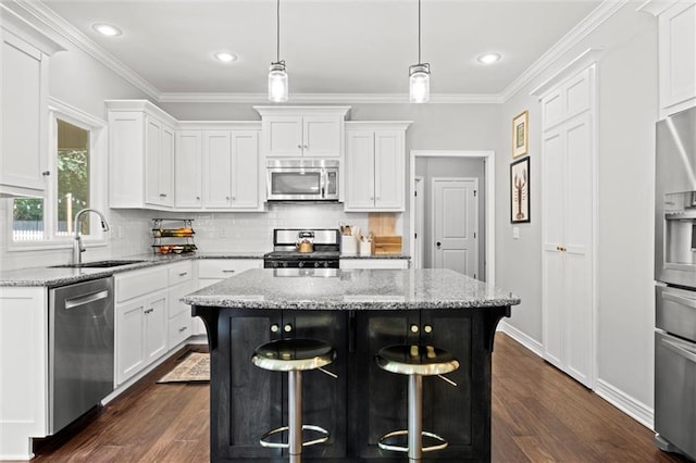 316 SE Hackamore Dr, Lees Summit, MO 64082 - kitchen with stainless steel appliances, a center island, white cabinets, crown molding, and dark wood-style flooring