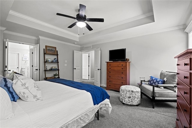 316 SE Hackamore Dr, Lees Summit, MO 64082 - carpeted bedroom featuring a raised ceiling, ornamental molding, a ceiling fan, and connected bathroom