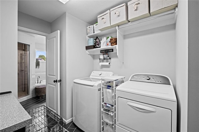 316 SE Hackamore Dr, Lees Summit, MO 64082 - laundry room featuring washer and clothes dryer and dark tile patterned flooring
