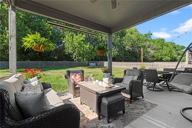 316 SE Hackamore Dr, Lees Summit, MO 64082 - fenced backyard with an outdoor hangout area, outdoor dining area, and ceiling fan