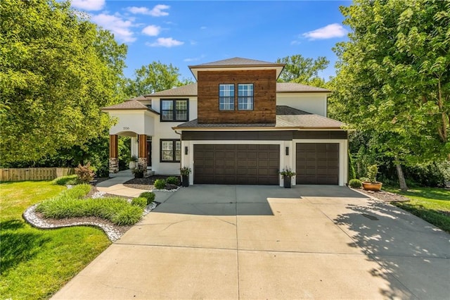 3536 SW Dana Ave, Lees Summit, MO 64082 - view of front facade featuring stucco siding, driveway, a garage, and roof with shingles