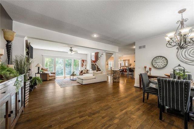 3536 SW Dana Ave, Lees Summit, MO 64082 - living room featuring a chandelier, stairs, dark wood-style floors, ceiling fan, and a textured ceiling