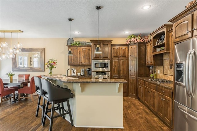 3536 SW Dana Ave, Lees Summit, MO 64082 - kitchen featuring stainless steel appliances, dark wood-style flooring, backsplash, a textured ceiling, and recessed lighting